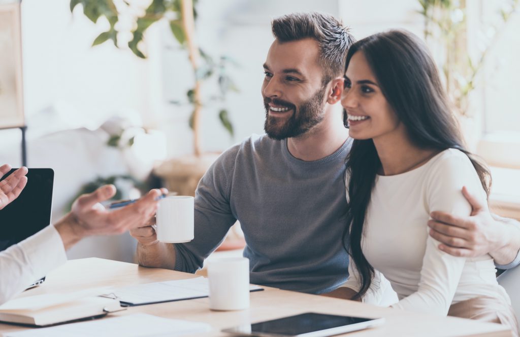 A happy couple talking to home builder expert