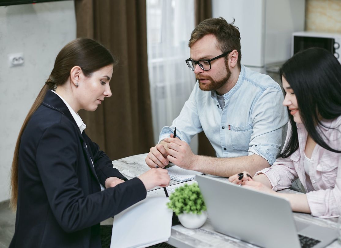 Young couple talking to home loans lender