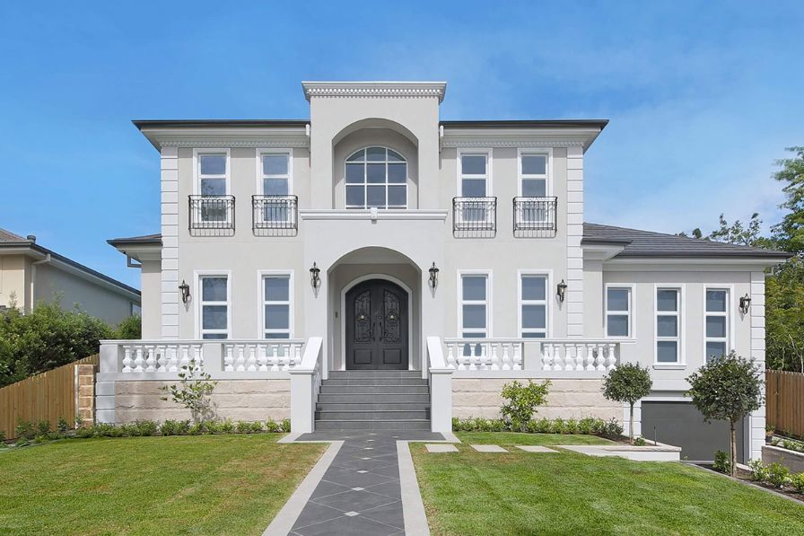 2 storey white home with curved entrance archway