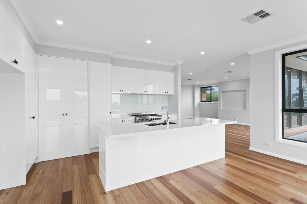 White kitchen island on wood floor